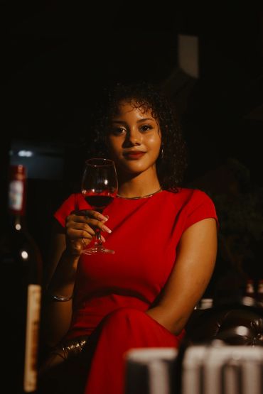 Elegant woman enjoying Alpha Antares wine
