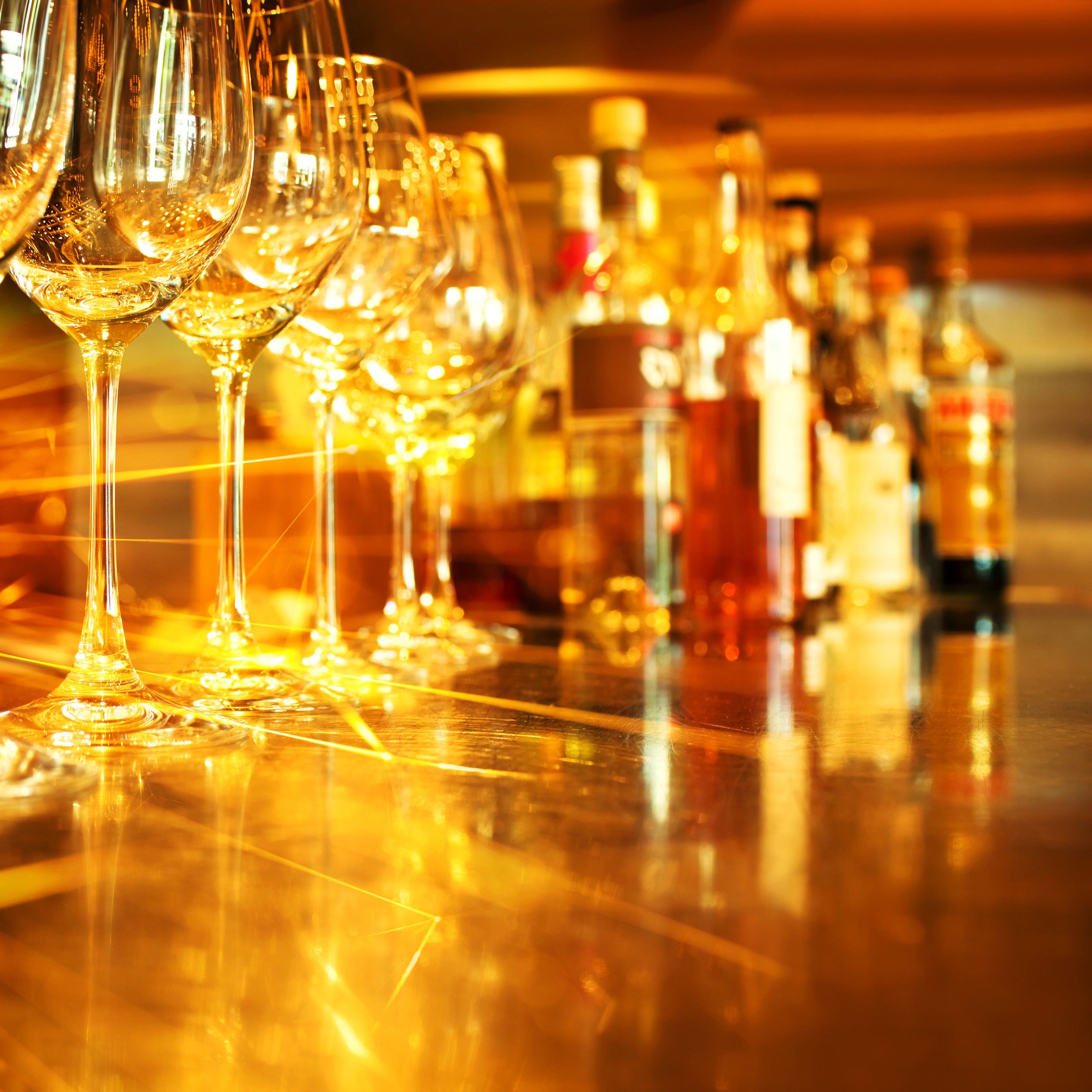 Wine glasses on a wooden table with golden light